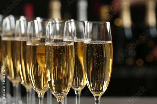 Many glasses of champagne on blurred background, closeup