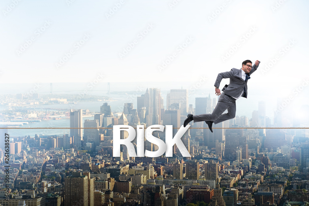Businessman in risk concept walking on tight rope Businessman in risk concept walking on tight rope