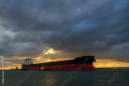 Cargo ship in sea at sunrise, Newcastle Harbour, NSW, Australia