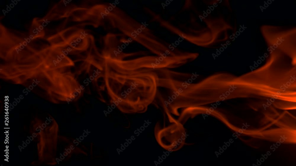 Vertical video screensaver - Fiery red smoke billow rising swirl up, isolated on black background. Colored smoke blowing from the right side. Closeup, isolated on black background.
