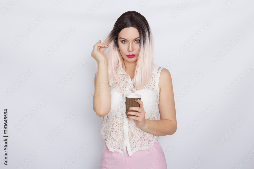 Blonde woman in white shirt with cup of coffee Blonde woman in white shirt with cup of coffee