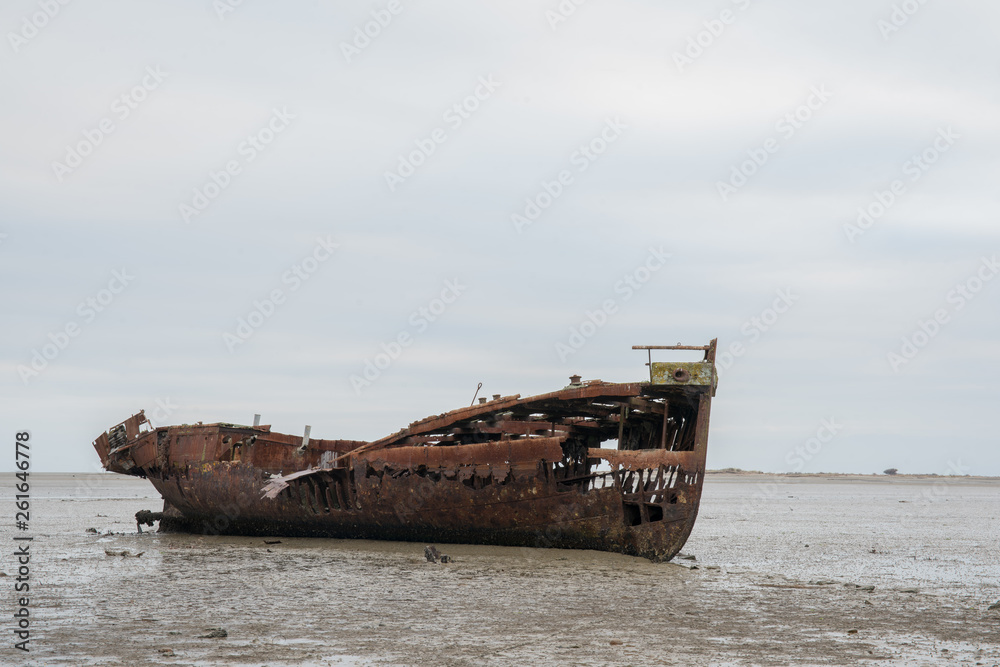 Abandoned shipwreck on the mud flats