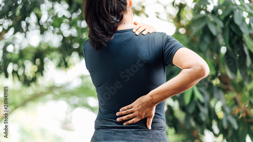 young asian woman hurts her back and neck, Ache in human body , office syndrome , health care concept