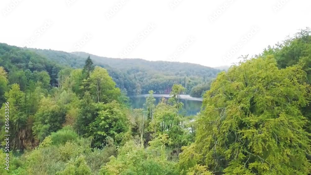 Plitvice Lakes National Park, Aerial reveal of beautiful waterfall cascading over ancient untouched landscape