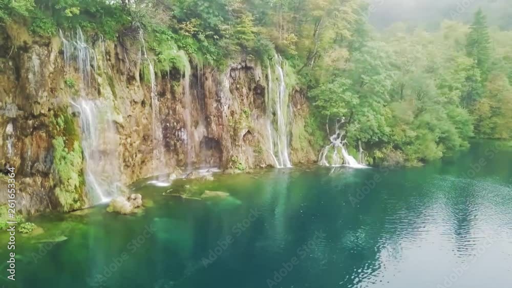 Breathtaking deep green water of Plitvice Lakes National Park, Aerial pan around picturesque waterfalls Breathtaking deep green water of Plitvice Lakes National Park, Aerial pan around picturesque waterfalls