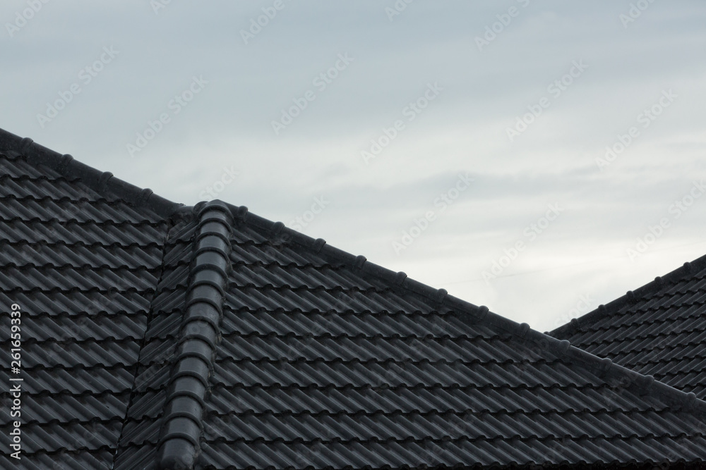rain storm downpour on black roof tile of residential house rain storm downpour on black roof tile of residential house