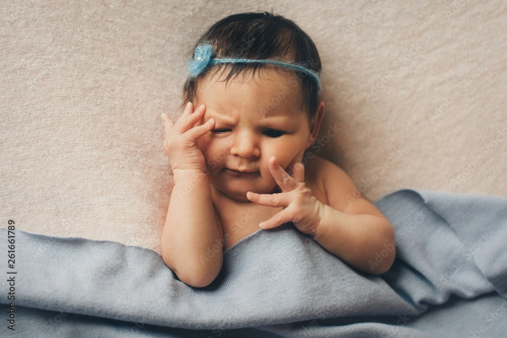 portrait of a newborn baby with a pen at the face portrait of a newborn baby with a pen at the face