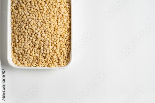 Fotografie couscous croup on white background, top view, place for text