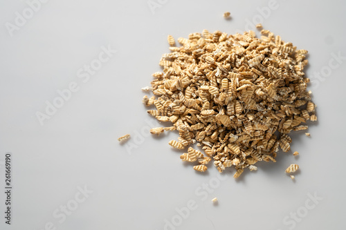 raw syrodavlennaya oatmeal on a white background, top view, space for text