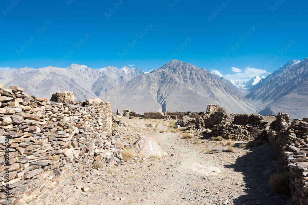 Pamir Mountains, Tajikistan - Aug 22 2018: Ruins of Yamchun Fort in the Wakhan Valley in Gorno-Badakhshan, Tajikistan. It is located in the Tajikistan and Afghanistan border. Pamir Mountains, Tajikistan - Aug 22 2018: Ruins of Yamchun Fort in the Wakhan Valley in Gorno-Badakhshan, Tajikistan. It is located in the Tajikistan and Afghanistan border.