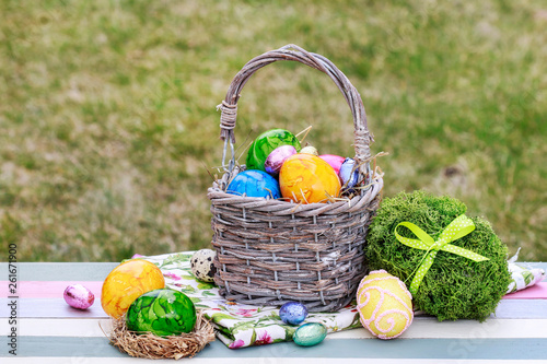 Traditional Easter basket with colorful eggs.