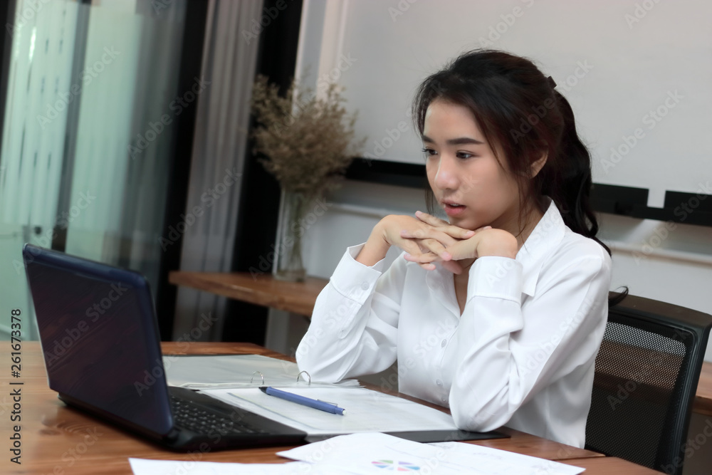 Attractive young Asian businesswoman working on the workplace in office. Thinking and thoughtful business concept. Attractive young Asian businesswoman working on the workplace in office. Thinking and thoughtful business concept.