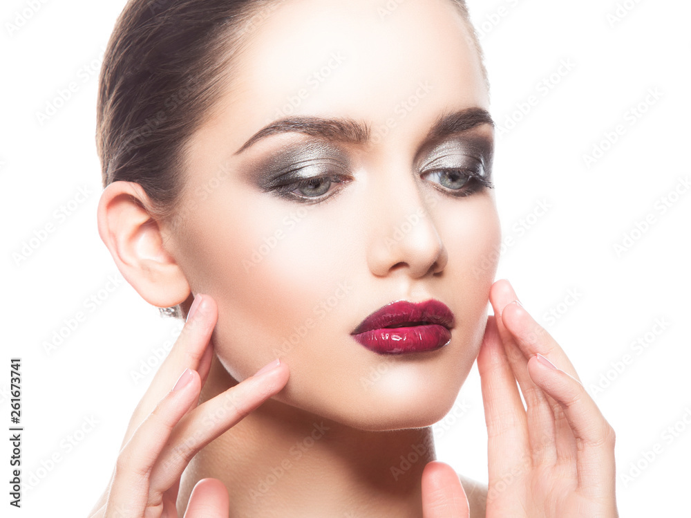 Beauty fashion portrait of caucasian brunette woman with glossy wet red lipstick and hands touching face. Isolated. White background Beauty fashion portrait of caucasian brunette woman with glossy wet red lipstick and hands touching face. Isolated. White background