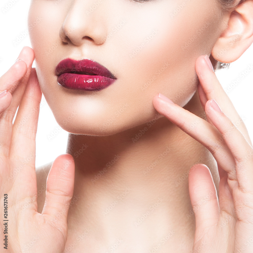 Close-up red lips, oman part of face, clean skin, hands touching cheek. Facial treatment concept Close-up red lips, oman part of face, clean skin, hands touching cheek. Facial treatment concept