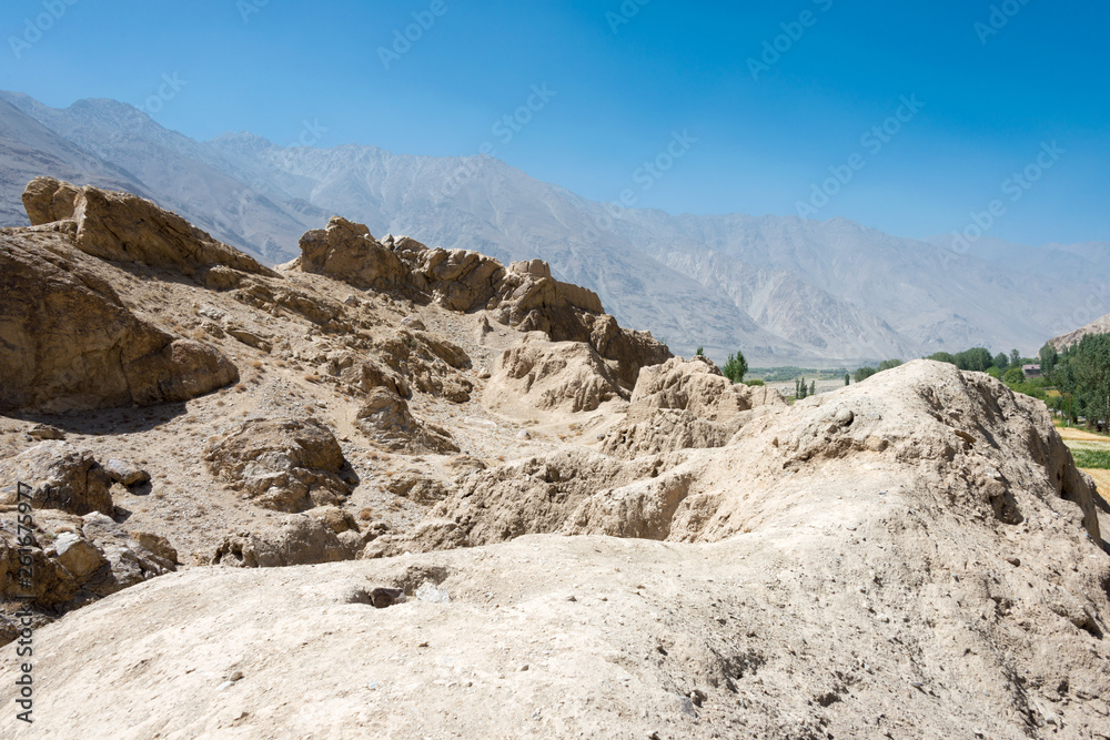 Ishkashim, Tajikistan - Aug 23 2018: Ruins of Khaakha Fortress in the Wakhan Valley in Ishkashim, Gorno-Badakhshan, Tajikistan. It is located in the Tajikistan and Afghanistan border. Ishkashim, Tajikistan - Aug 23 2018: Ruins of Khaakha Fortress in the Wakhan Valley in Ishkashim, Gorno-Badakhshan, Tajikistan. It is located in the Tajikistan and Afghanistan border.