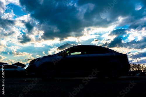 car silhouette on evening sky during the sunset b © Mihail
