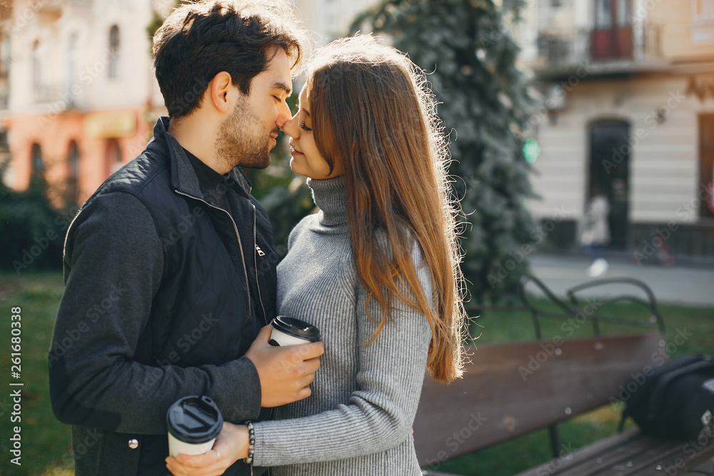 Cute couple in a spring city. Lady with long hair. Man in a black jacket Cute couple in a spring city. Lady with long hair. Man in a black jacket