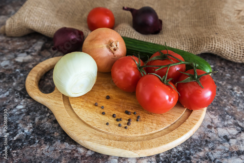 Fresh vegetables - onions, tomatoes, cucumber on a table