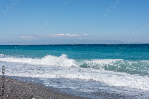 Fototapeta Naklejka Na Ścianę i Meble -  Waves Washing Ashore on a Black Sand Volcanic Beach in Sicily