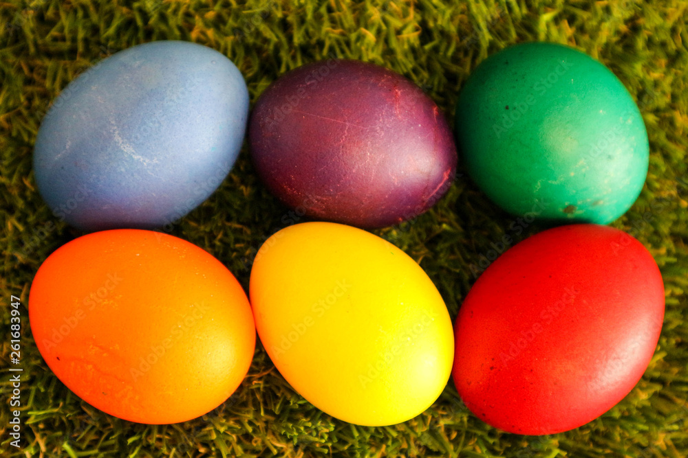 Six easter egg row on green grass background Six easter egg row on green grass background