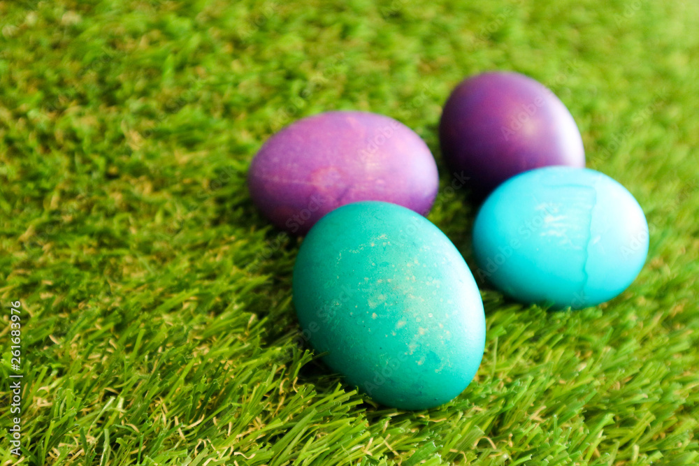 Blue and azure easter eggs in the green grass