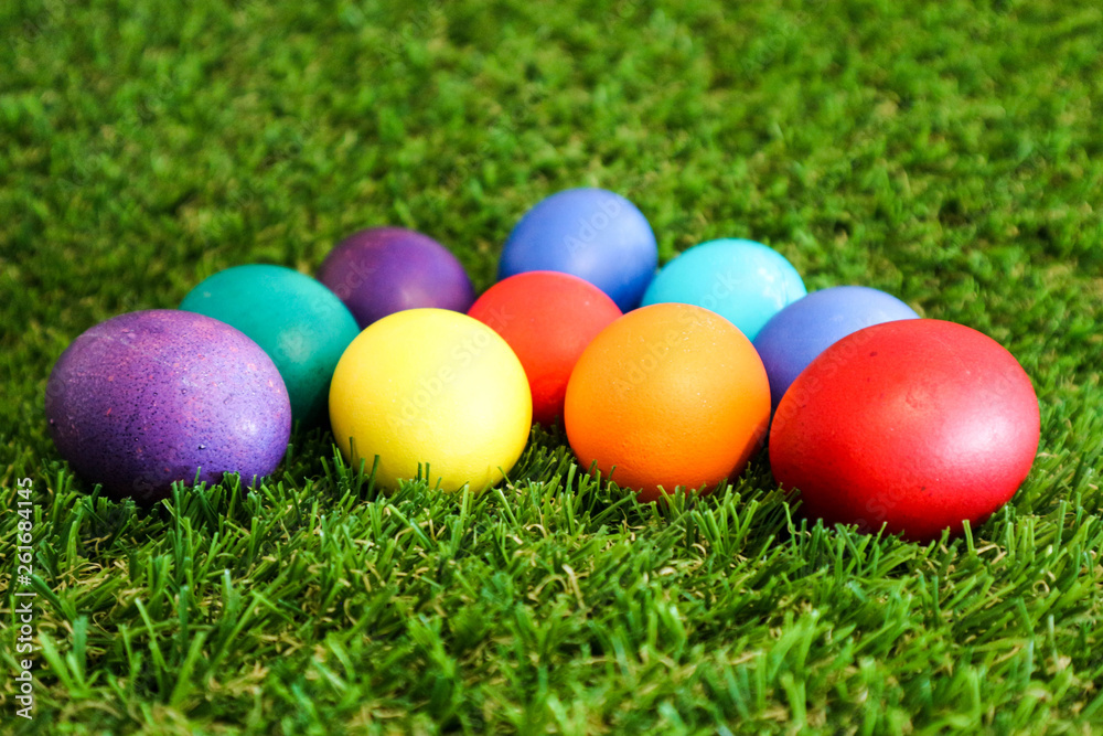 Beautiful bright colorful easter eggs in green grass closeup