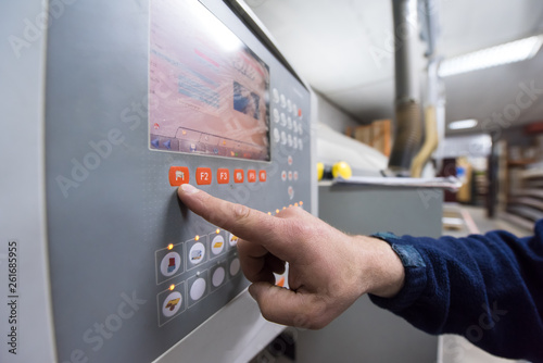 carpenter calculating and programming a cnc wood working machine