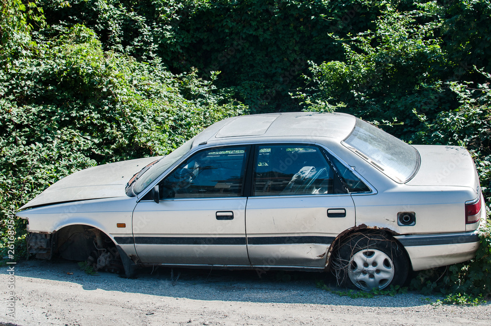 Old crushed cars bodies stored in auto wrecking junk yard for scrap and spare parts Old crushed cars bodies stored in auto wrecking junk yard for scrap and spare parts