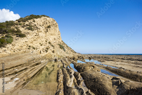 Sedimentary rocks and tide pools at the coastline in Karpas Peninsula, Northern Cyprus photo
