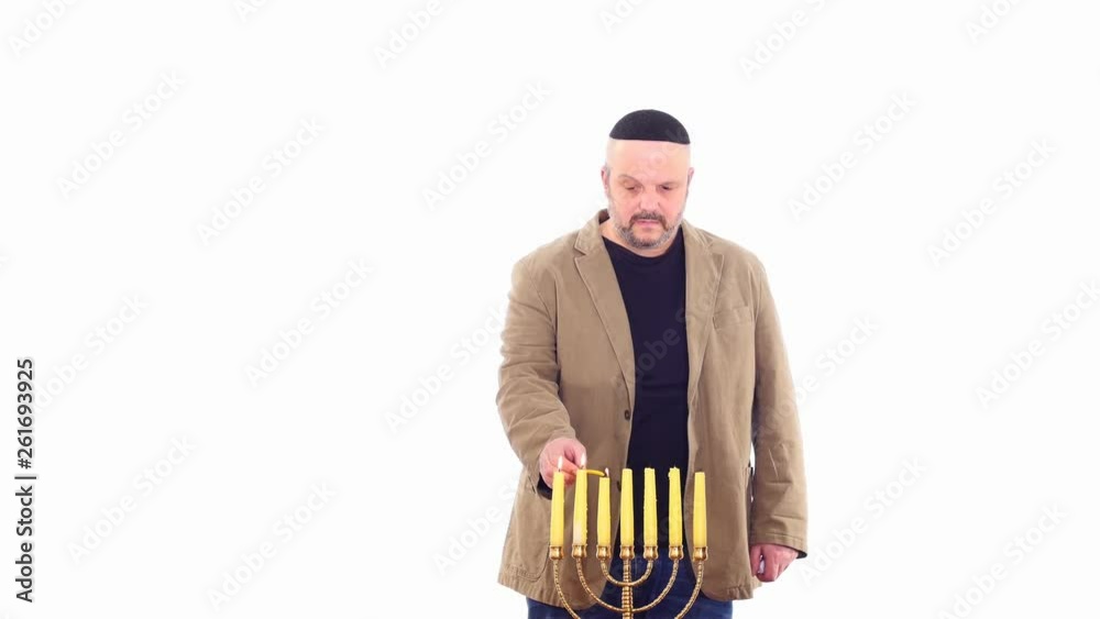 Jewish man ignites Menorah time lapse white screen Jewish man ignites Menorah time lapse white screen