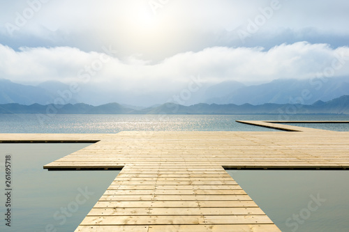 Wooden floor platform and lake with sky background © ABCDstock