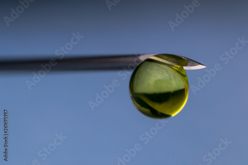 macro view of a hypodemic needle with a drop of drug solution on his peak photo