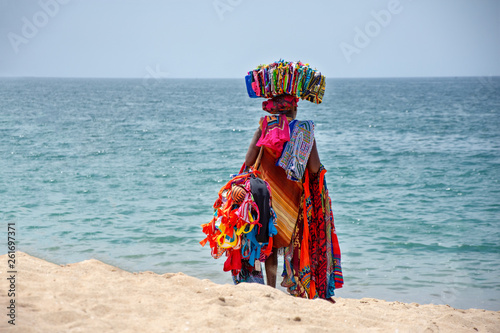African woman sell traditional costume cloths on the beach, zungueira - Luanda, Angola, Africa