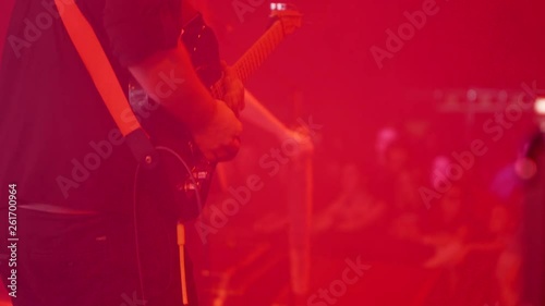 Lead guitar player on stage at a rock music event. Playing on a rock event in front of an audience.