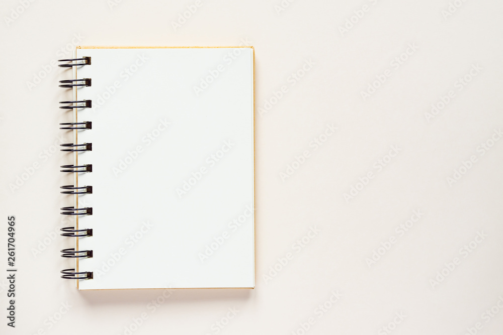 Clean spiral note book for notes and messages on rlight beige background. Minimal business flat lay Clean spiral note book for notes and messages on rlight beige background. Minimal business flat lay