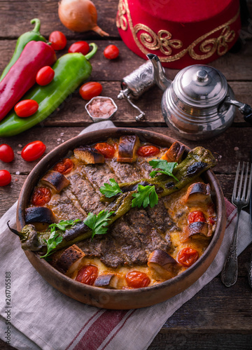 Turkish kebab in a ceramic pot with vegetables