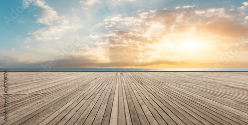 Wooden floor platform and blue sea with sky background photo
