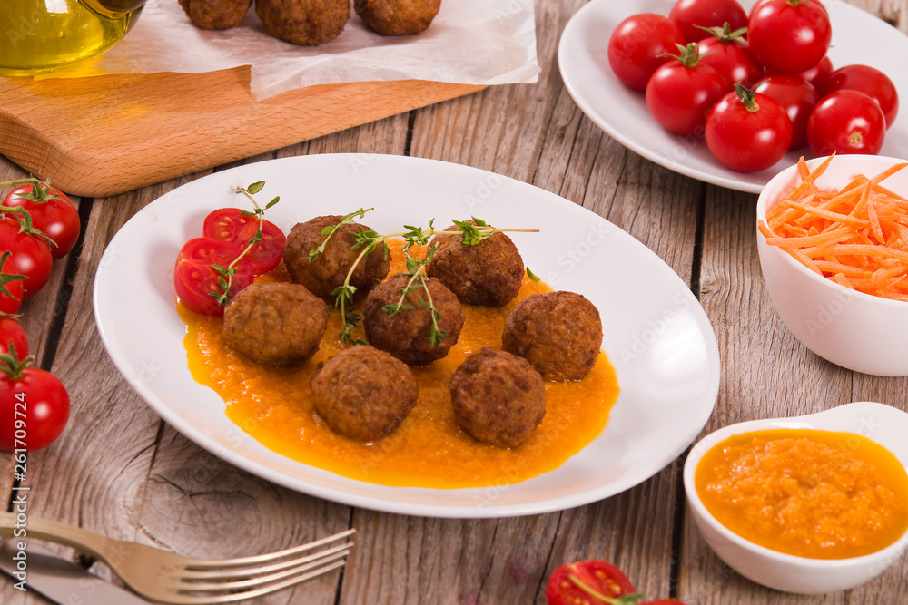 Meatballs with mashed carrots.