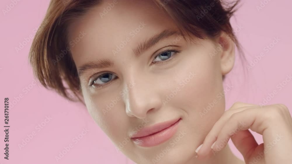 Young brunette woman with smooth healthy skin looks at camera Young brunette woman with smooth healthy skin looks at camera