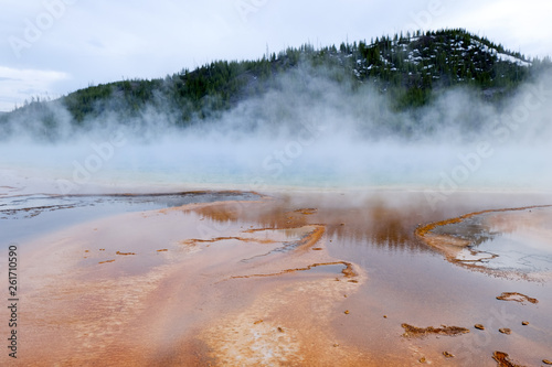 colorful geothermal pool with mountain background in yellowstone (Grand Prismatic Spring)