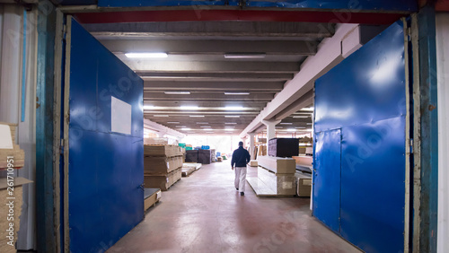 carpenter walking through factory