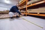 carpenter measuring wooden board