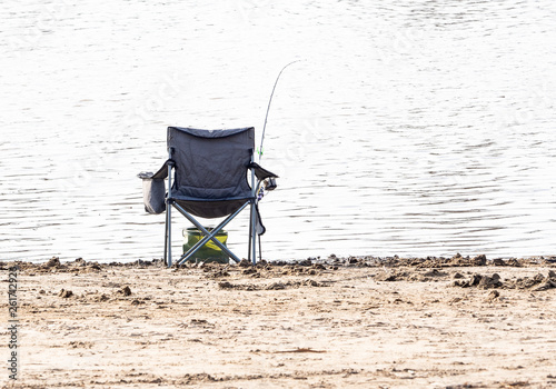 Fishing rod, fishing chair, on the background of the river. Fishing on the river.