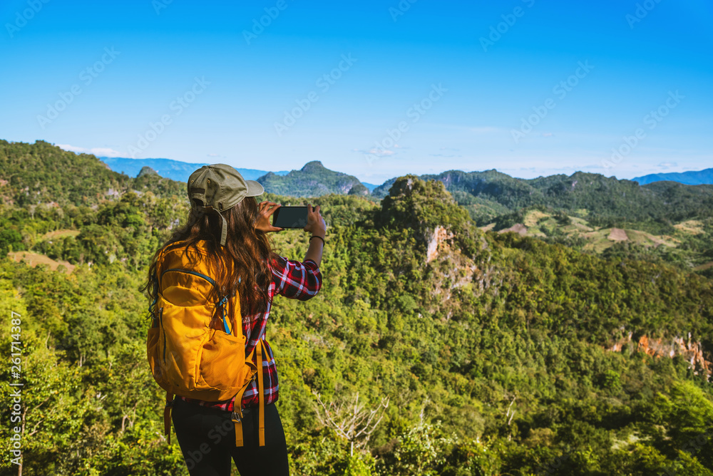 The woman standing at the view point. Enjoy shooting the natural beauty of the mountains. The woman standing at the view point. Enjoy shooting the natural beauty of the mountains.