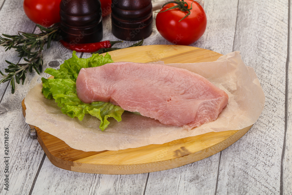 Raw Turkey steak served rosemary