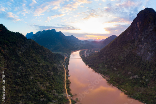 Aerial panoramic Nam Ou River Nong Khiaw Muang Ngoi Laos, sunset dramatic sky, scenic mountain landscape, famous travel destination in South East Asia