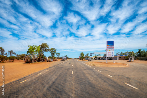 Petrol station in Australian dessert along endless straight road photo
