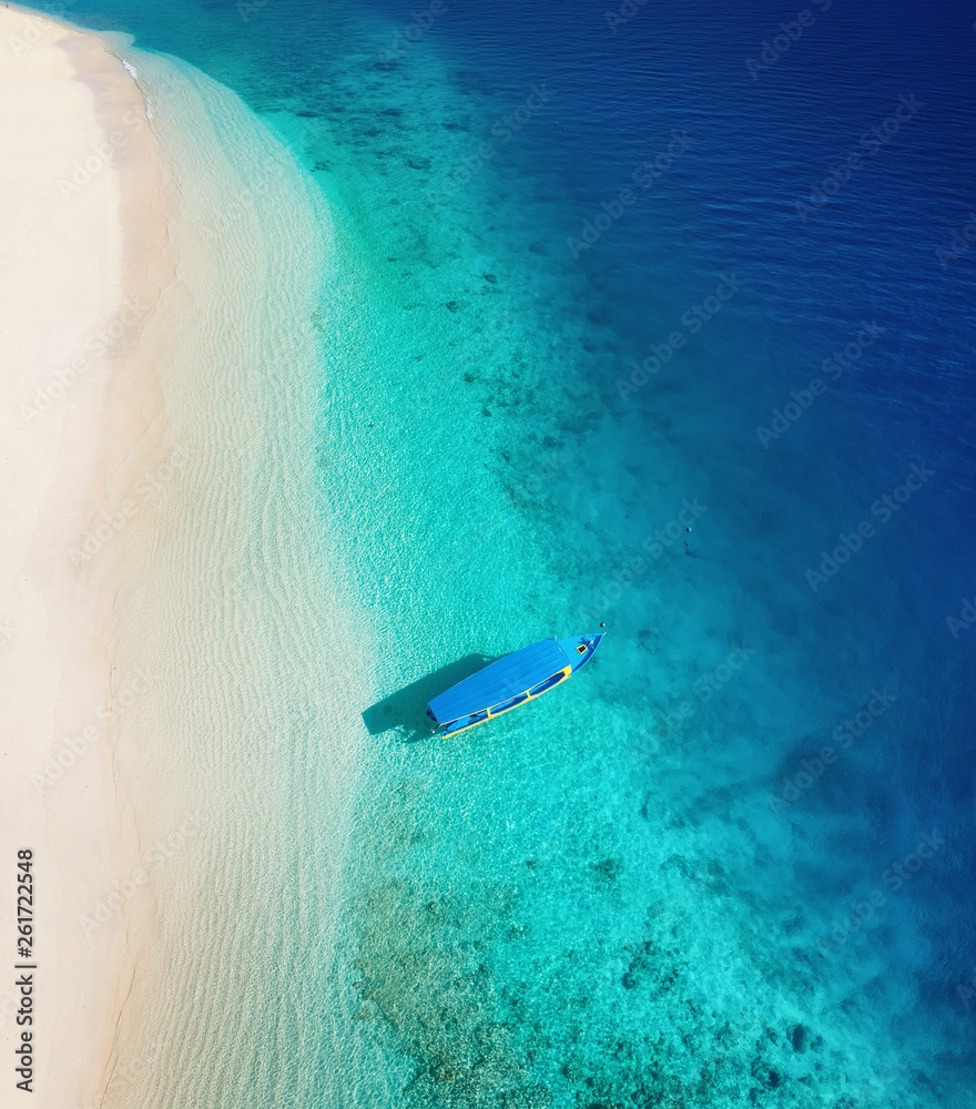 Boat on the water surface from top view. Turquoise water background from top view. Summer seascape from air. Gili Meno island, Indonesia. Travel - image Boat on the water surface from top view. Turquoise water background from top view. Summer seascape from air. Gili Meno island, Indonesia. Travel - image