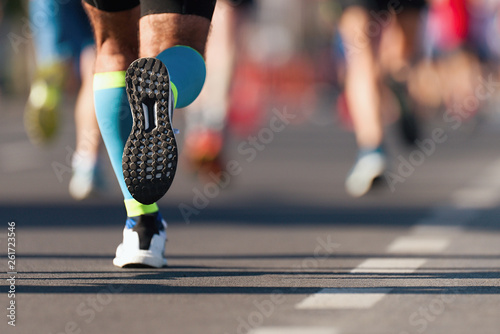 Fototapeta Naklejka Na Ścianę i Meble -  Marathon running race, people feet on city road