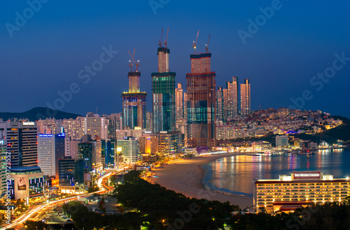 Busan beach view from roof top of hotel in Busan city in night time with blue sky and full moon, South Korea, this picture can use for tavel, Busa, South Korea and city concept